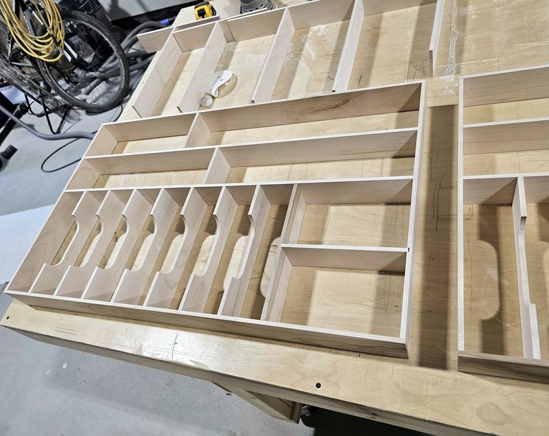 Wood drawer organizer insert with many small compartments being assembled on a workbench