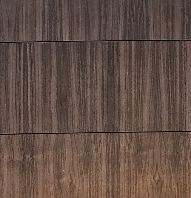 Walnut drawer fronts close up, showing straight, dark brown grain
